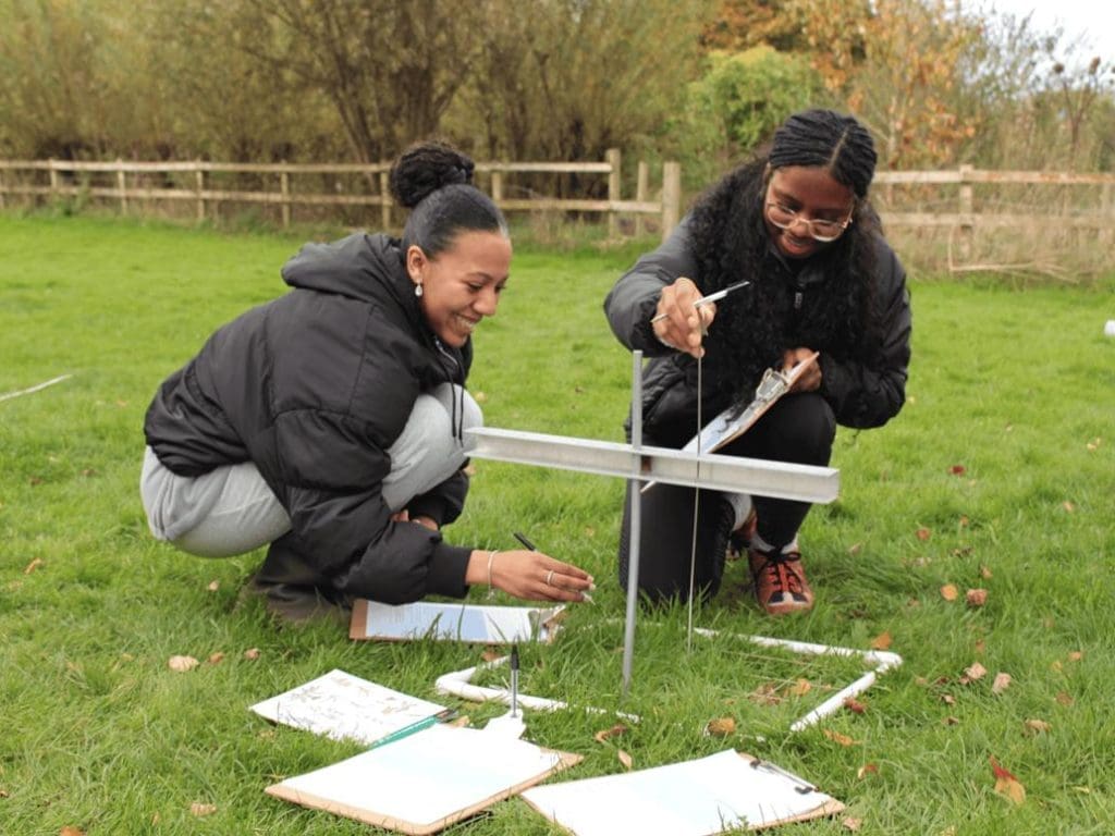 two students doing field studies outside
