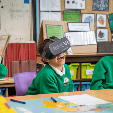 primary pupil wearing VR headset smiling