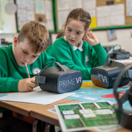 pupils in class writing in text books