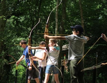 secondary school group doing archery on a range