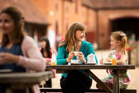 a family son on benches in an outside pick nick area