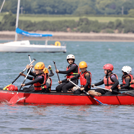 secondary school group in a large boat on a lake