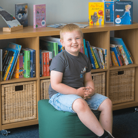 pupil in arts centre reading a book