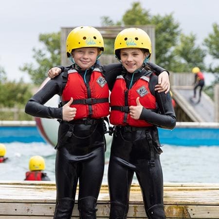 two school pupils doing water activities in a pool