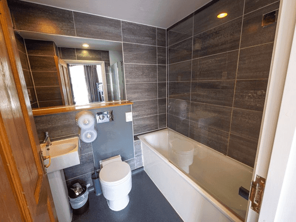 view of a shower room with sink and basin for educational groups