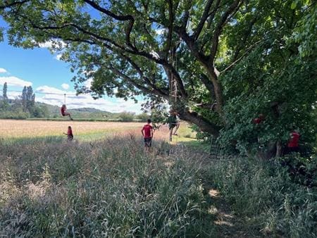 school pupils in a countryside field doing field studies
