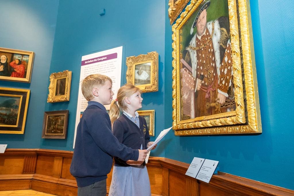 two primary school children looking at henry the eight painting