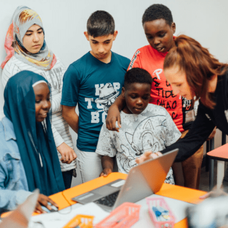 school group working on a laptop in a study room at the videogame museum