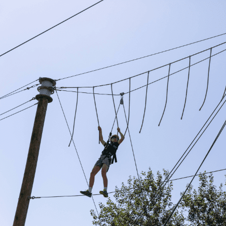school pupil on a high ropes course