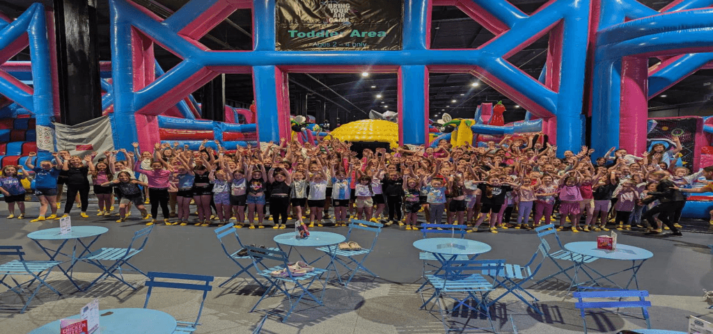 AirThrill Indoor Trampoline & Inflatable Park East Kilbride 5 school group smiling and waving at indoor trampoline activity centre