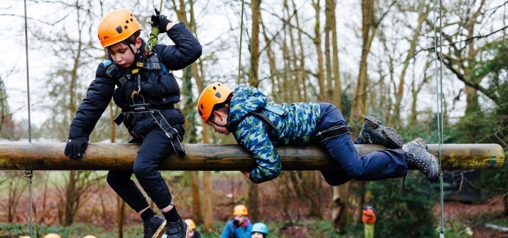 Scout Adventures Broadstone Warren Residential Centre 9 two school students on a wooden beam high up