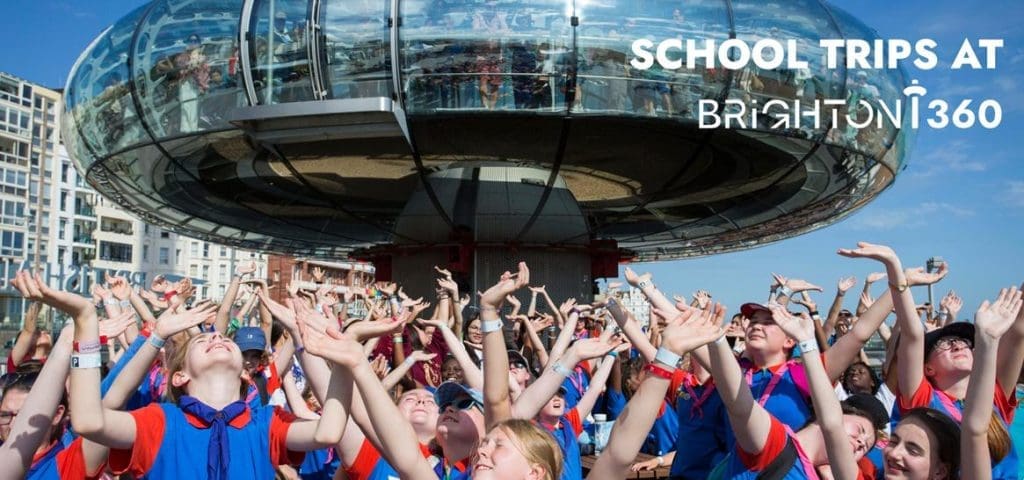 Brighton I360 Observation Tower 4 image showing school group with hands in the air and in the background the image of the i360