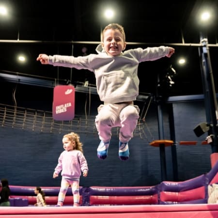 image shows primary school pupil jumping on trampolines