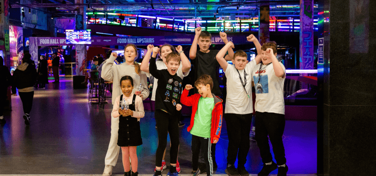 school group smiling and waving at Gravity Max