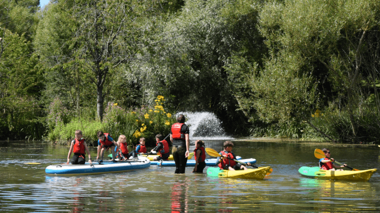 image of primary pupils kayaking in lake at Adventure 4 You Outdoor Activity Centre Northamptonshire