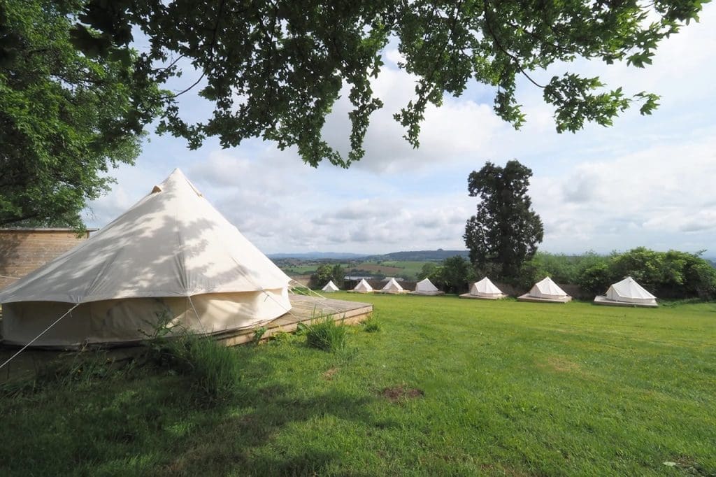 image of bell tents in fields at wilderness centre Forest of Dean