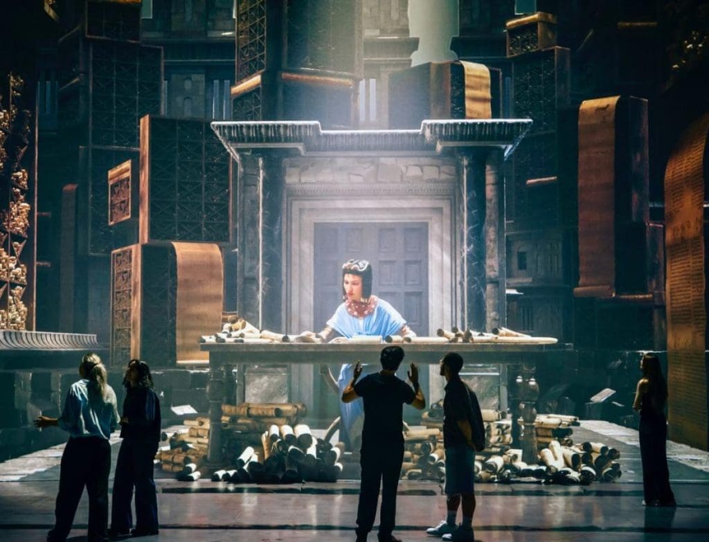 Cleopatra The Immersive Experience London 9 3D wall of Cleopatra with students looking on