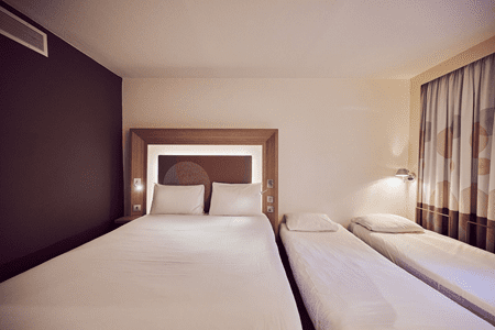 bedroom with three beds in it