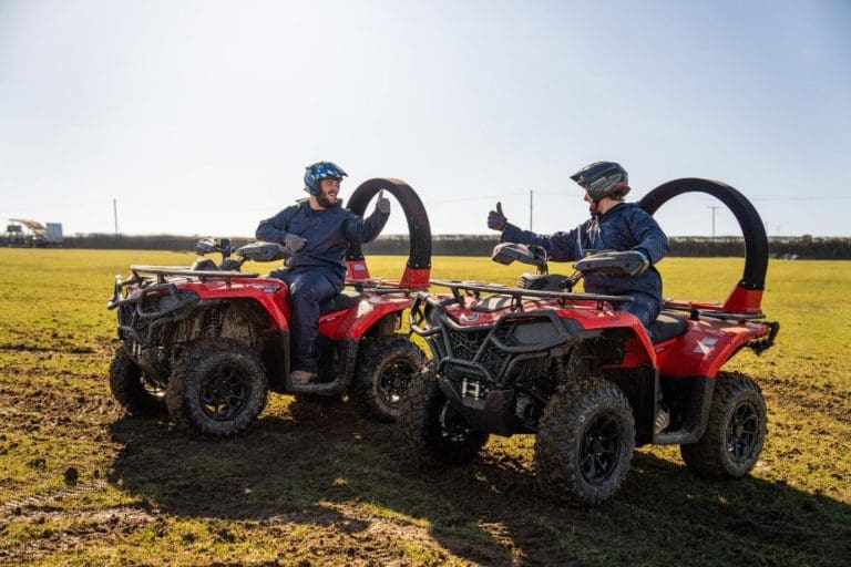 students on off road buggies in a field