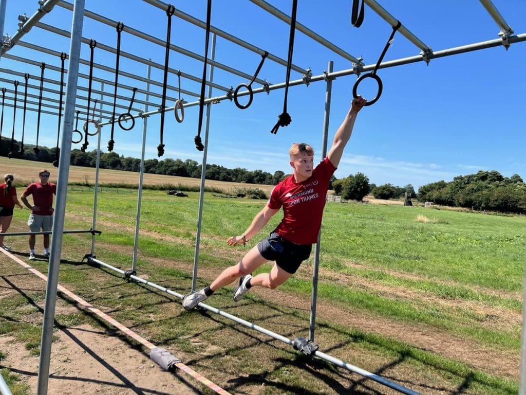 school pupil on monkey bars climbing frame
